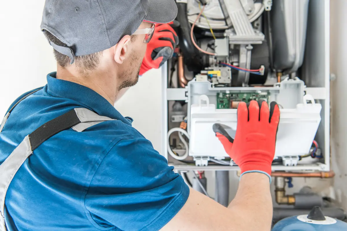 HVAC technician performing annual maintenance on a boiler in Atlanta